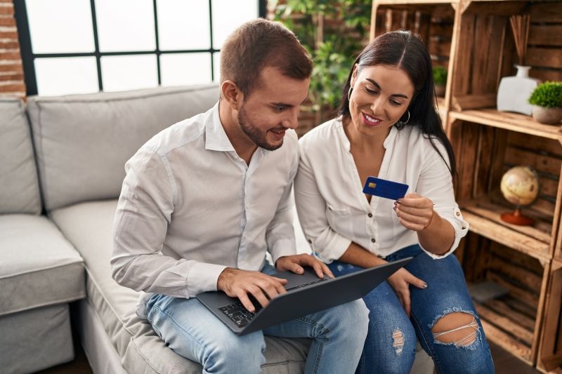 Couple buying online item while looking at laptop
